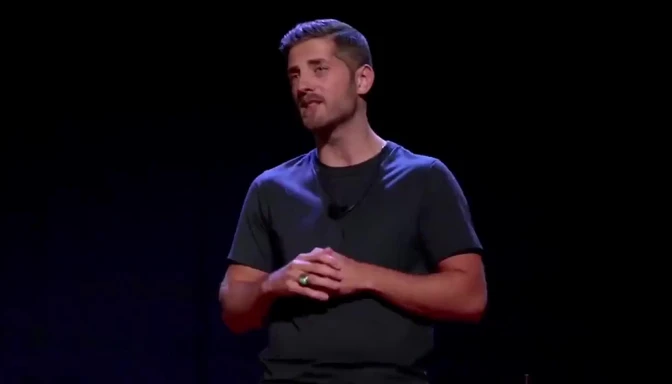 Reference image: man giving a talk on a dark stage