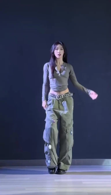 Reference image: woman dancing on a dark stage