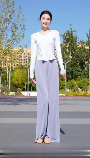 Reference image: woman standing in an outdoor plaza